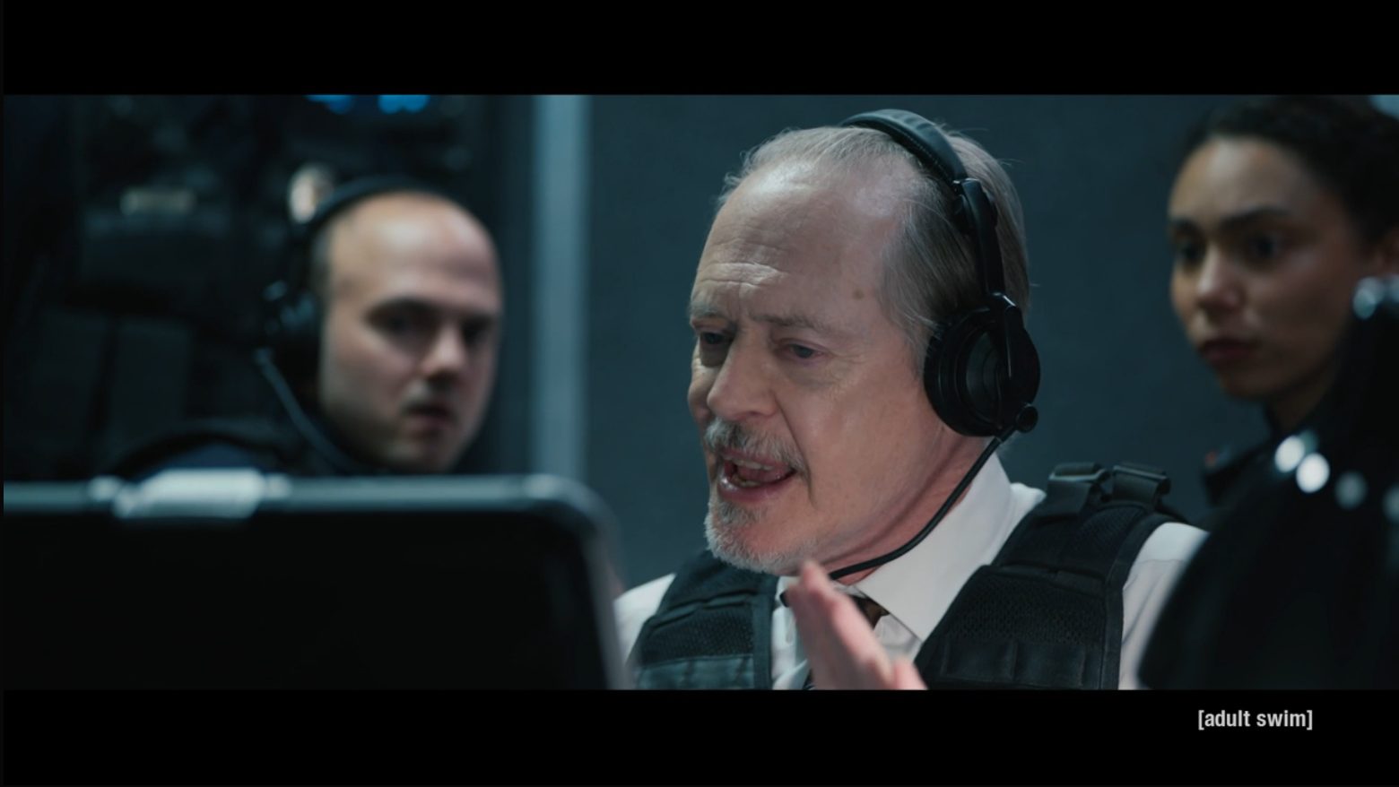 Steve Buscemi as Lt. James McMurphy in a headset and tactical vest.