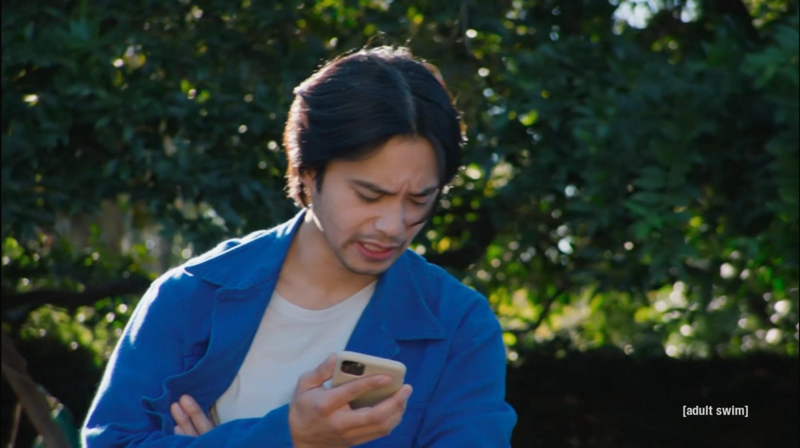 Jordan Mendoza outside on his phone, wincing at the call.