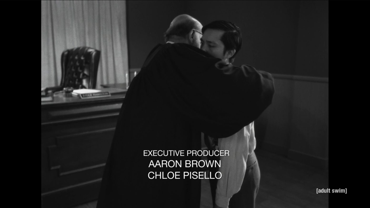 Judge Hamilton embracing Mr. Lang in the courtroom as end credits roll.
