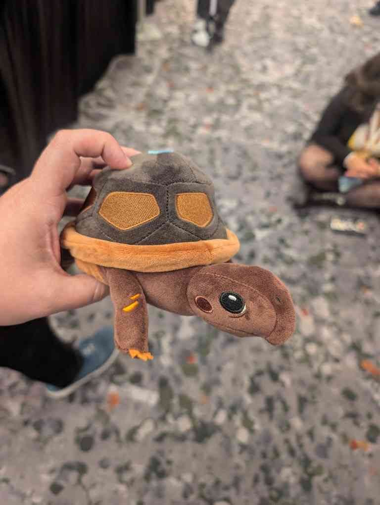 Socrates the turtle plush given out at the Common Side Effects NYCC panel