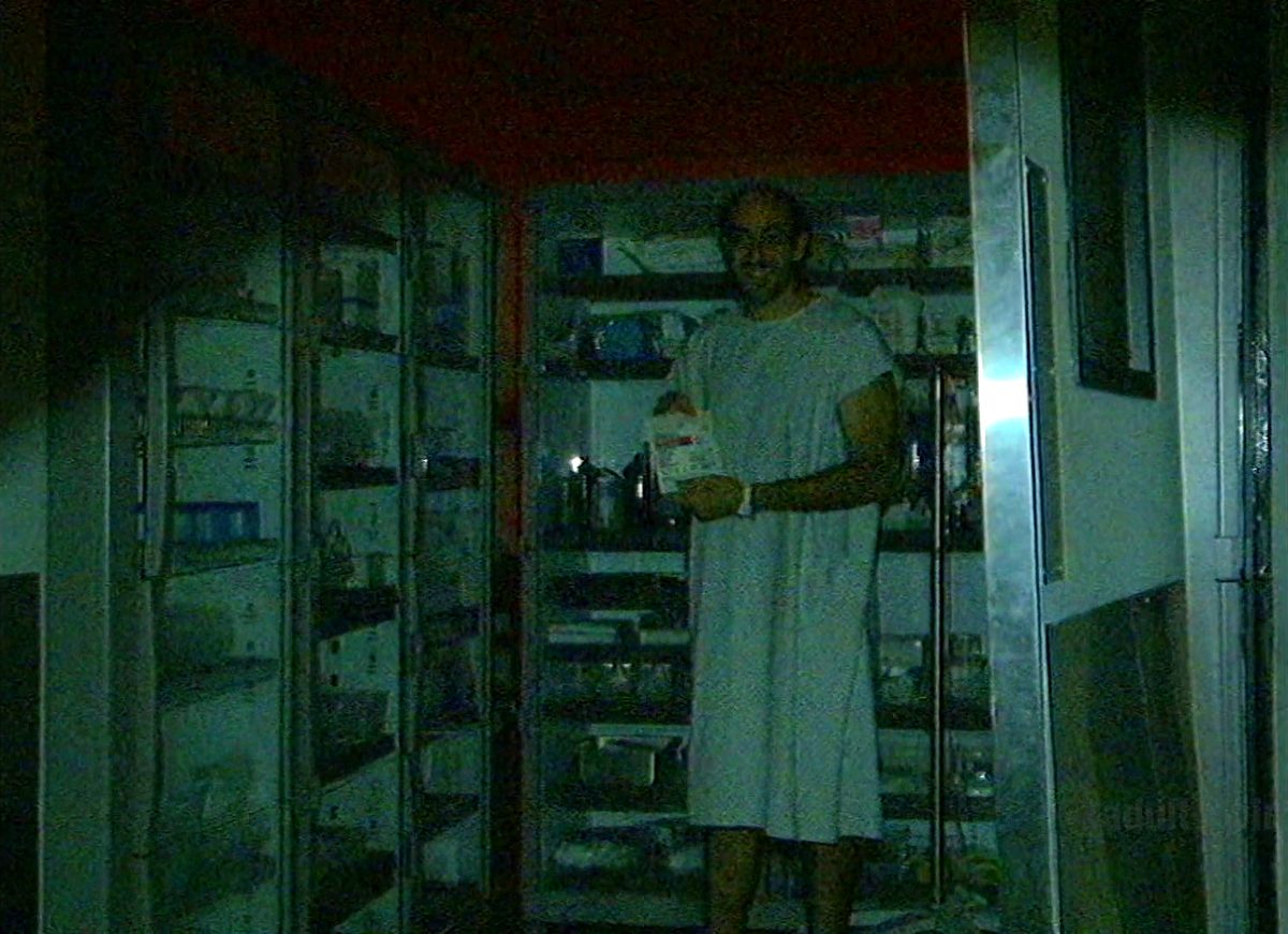 A patient in a medical supply closet, picking items off the shelves like Criterion DVDs
