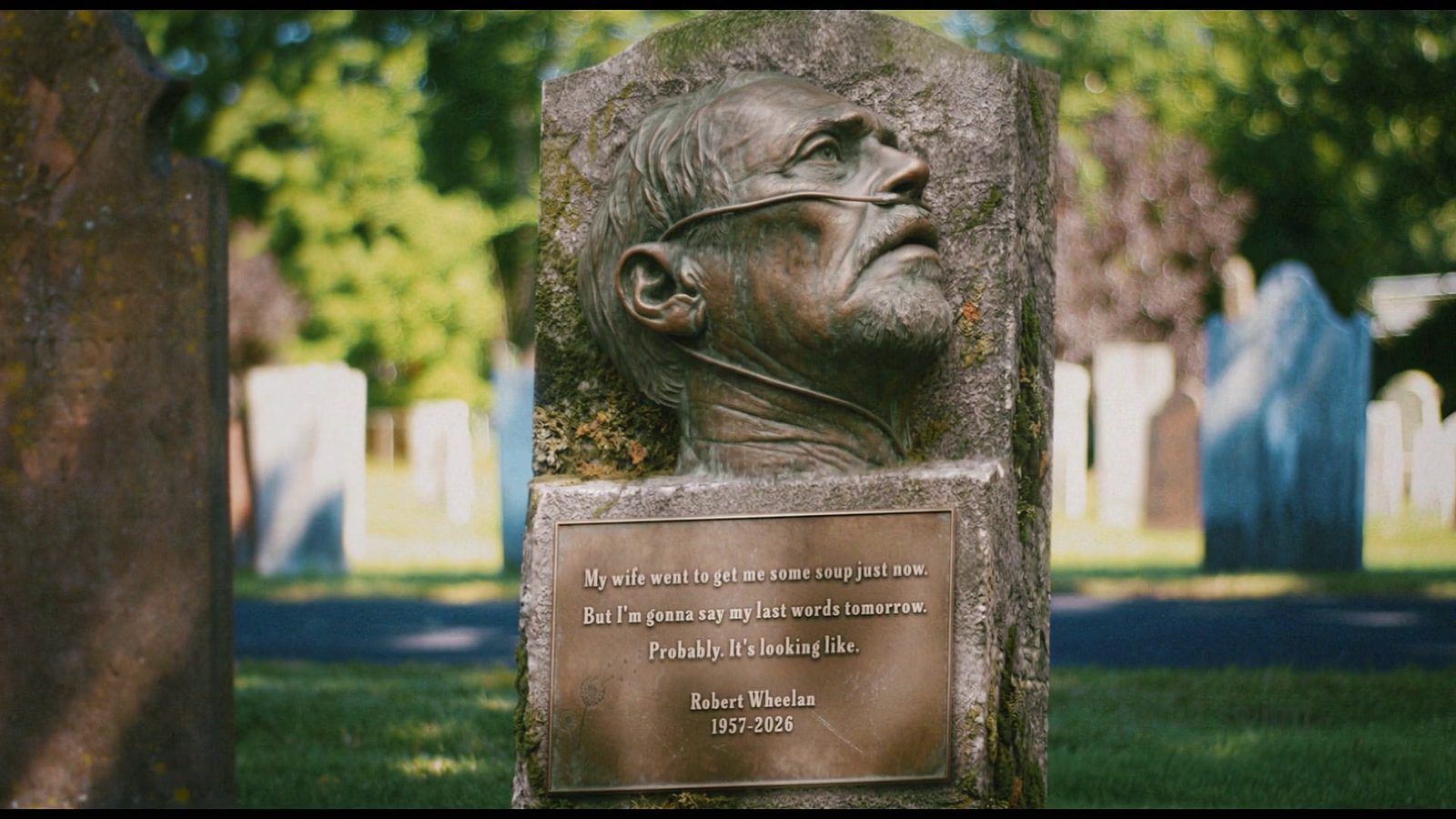 Robert Wheelan's tombstone, showing his final hospital-bed image and his actual last words